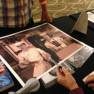 Derrik Lewis autographing a poster