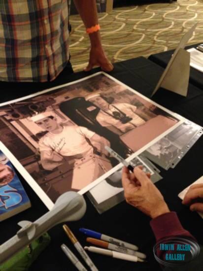 Derrik Lewis autographing a poster