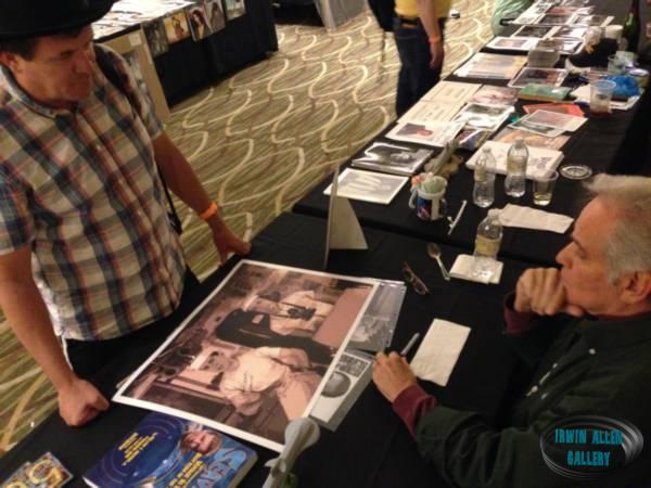 Derrik Lewis autographing a poster