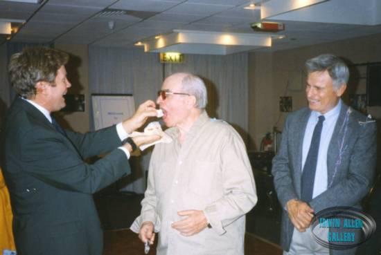Riley feeds the Chief as Kowalski watches