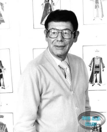 Irwin Allen in front of Alice in Wonderland costume drawings