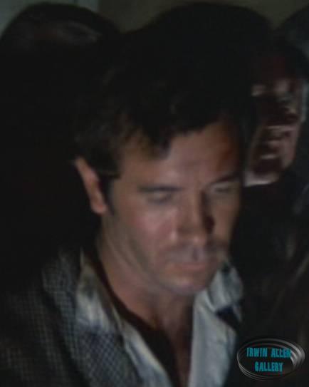 Man in group following Doctor