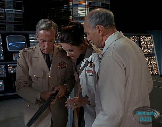 Time Tunnel staff examine sword